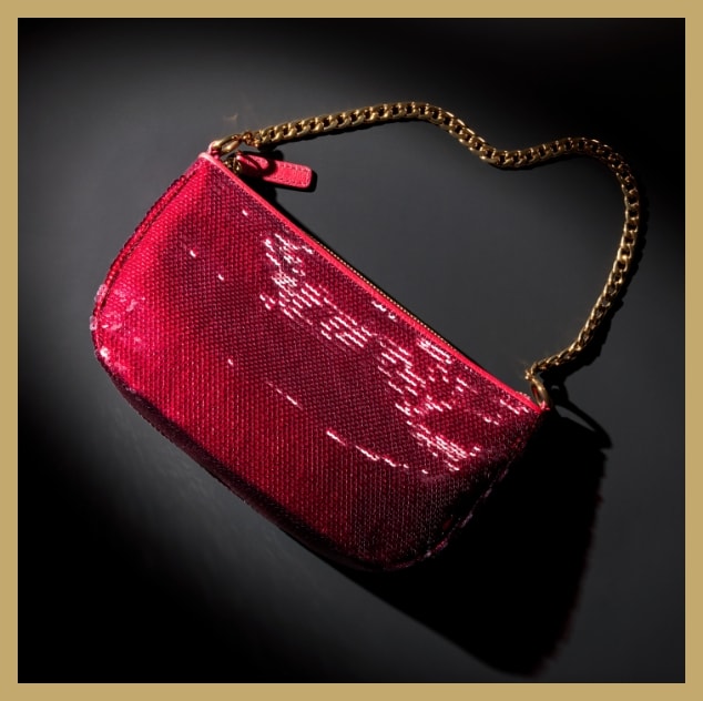 A red sequin bag with a gold-tone chain strap.