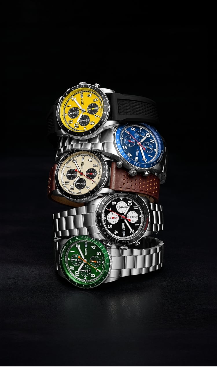 A stack of five Sport Tourer watches, featuring a yellow dial, blue dial, ivory dial, black dial and a green dial.