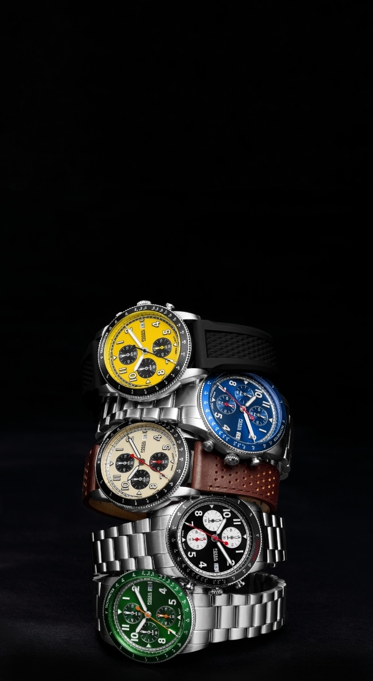 Five iterations of the Sport Tourer watch, including a black silicone with yellow dial; a stainless steel bracelet with black dial; a stainless steel bracelet with blue dial; a brown leather strap with cream dial; and a stainless steel bracelet with green dial.