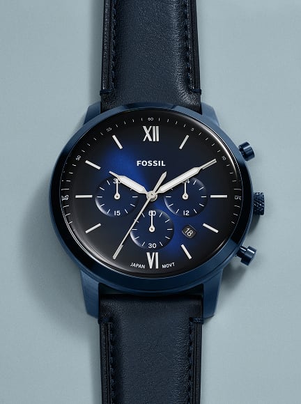 A silhouetted image of the midcentury Fossil Neutra Chronograph watch in a deep blue.