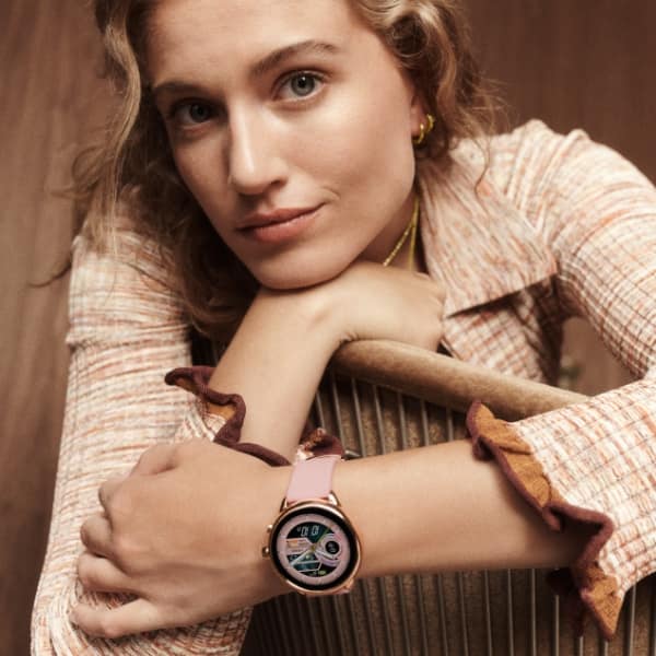 A woman wearing a Gen 6 Wellness Edition smartwatch.