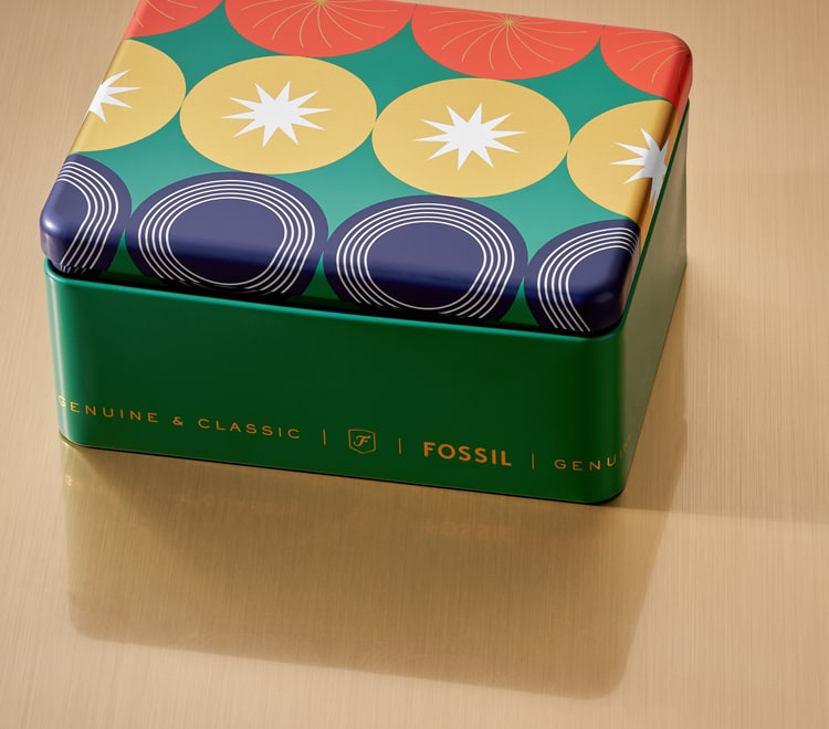 Gif of a brightly colored Fossil gift set tin opening to reveal a men's brown leather watch and brown leather bracelet.