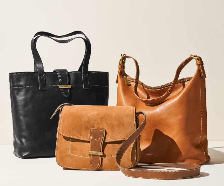 a collection of fossil leather bags