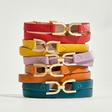 A brightly colored stack of Fossil Heritage leather bracelets. 