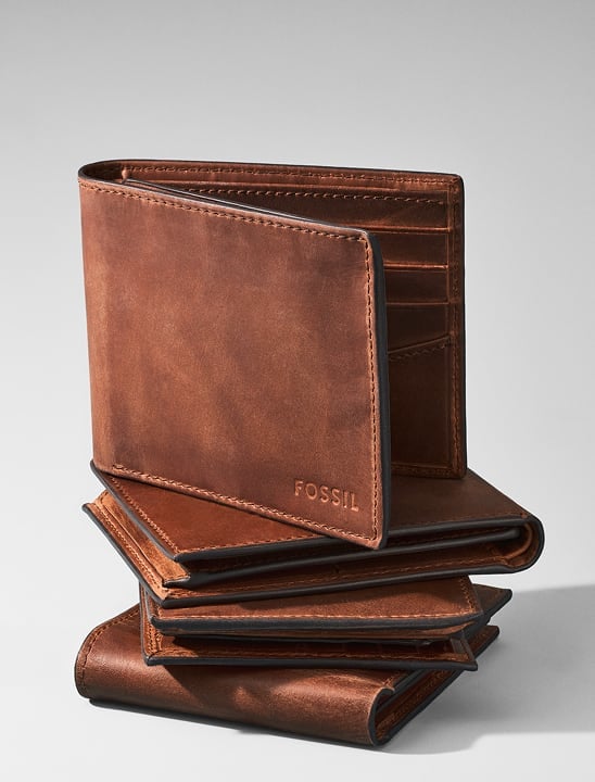 Image of a pile of stacked brown leather Fossil wallets.