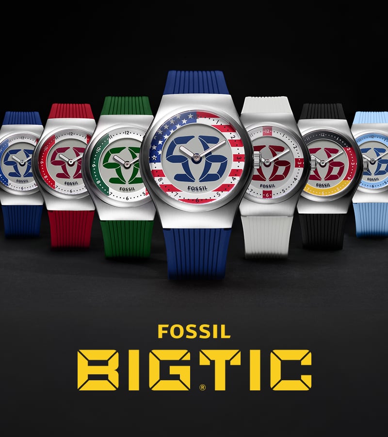 The Fossil Y2K Big Tic stainless steel watch with flickering digital flames, shown against a dark background with hot pink and blue lighting.