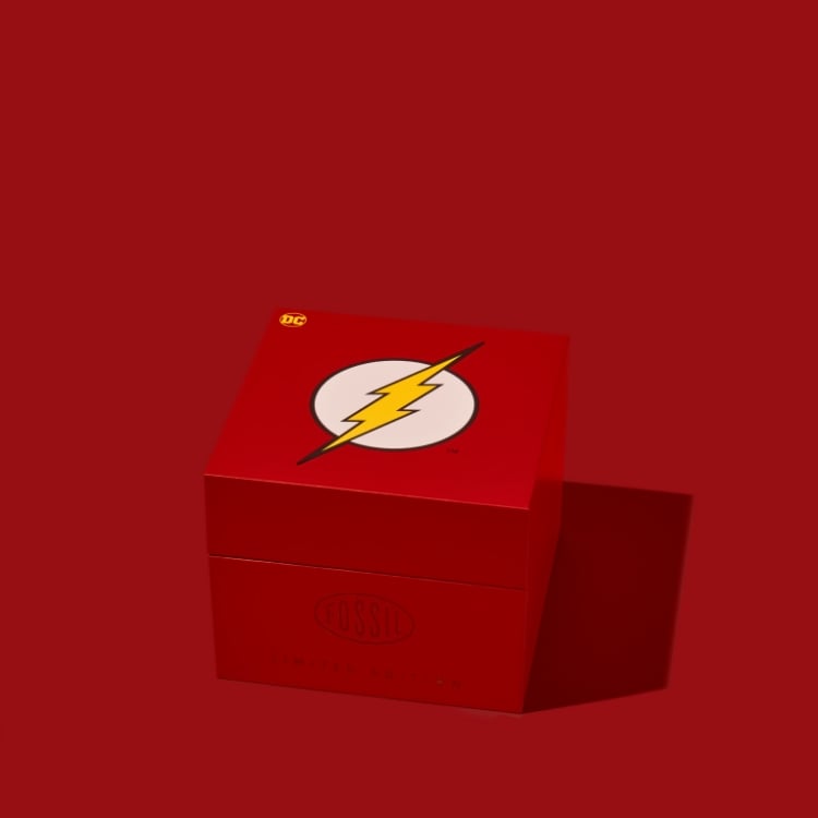 The Flash™ x Fossil watch packaging opening to reveal the limited-edition watch inside. 