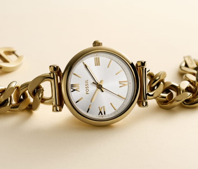 Jewellery-inspired Carlie watch in a gold-tone finish with a curb chain bracelet.