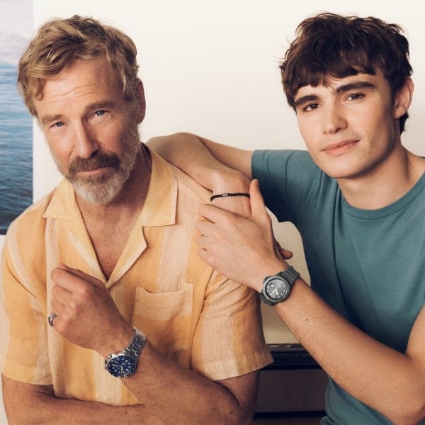A father with his son wearing Fossil products.