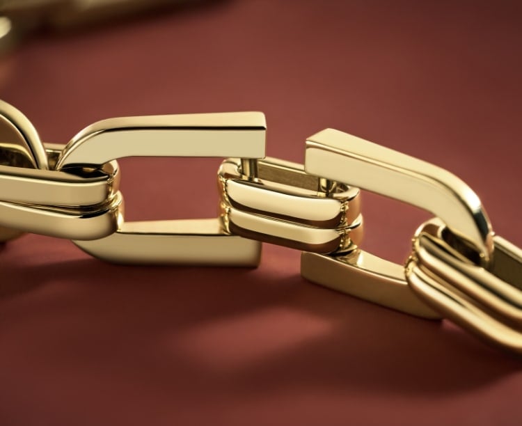 The gold-tone Heritage D-Link overlaid with a sketch.