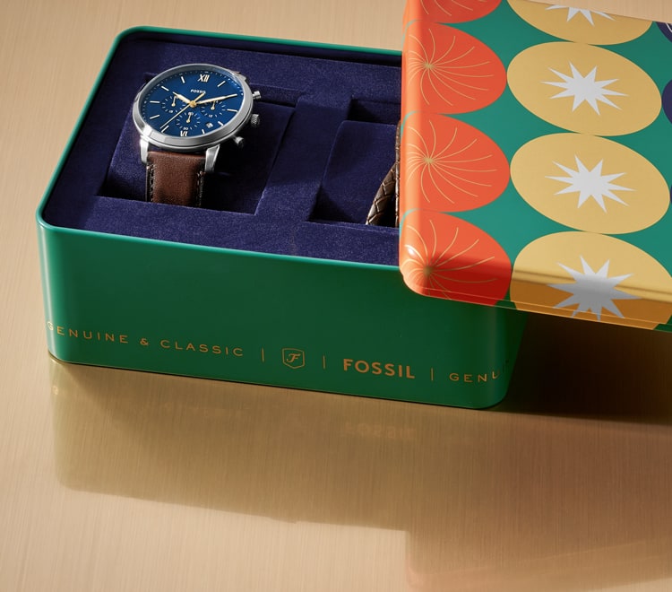 Gif of a brightly colored Fossil gift set tin opening to reveal a men's brown leather watch and brown leather bracelet.