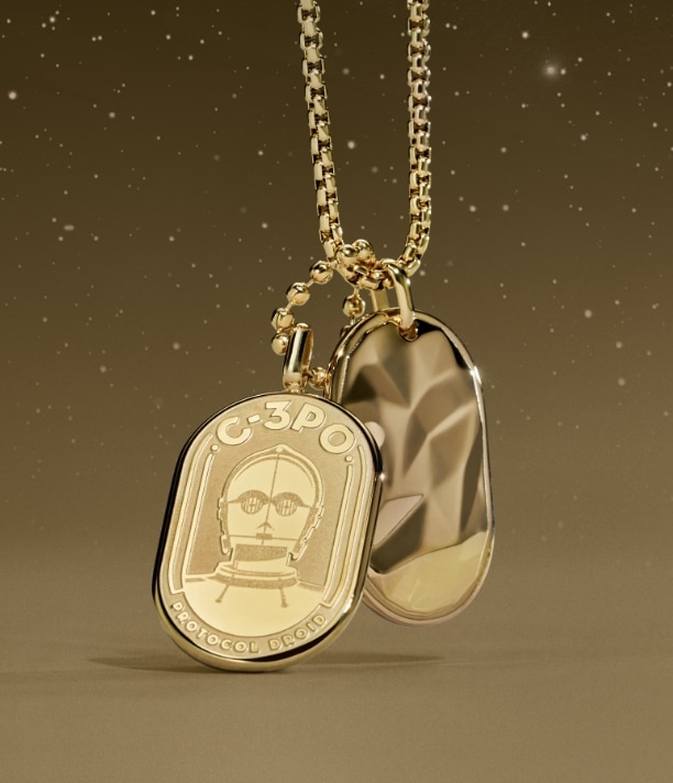 A gold-tone necklace with an engraving of C-3PO on an ID plaque