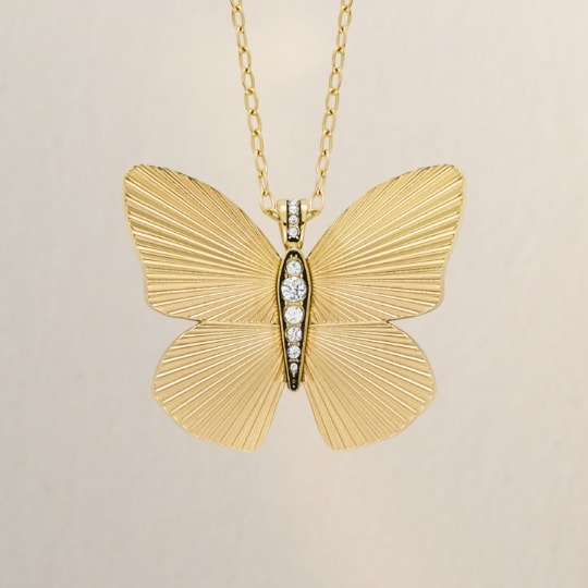Gold-tone butterfly necklace with glitz.