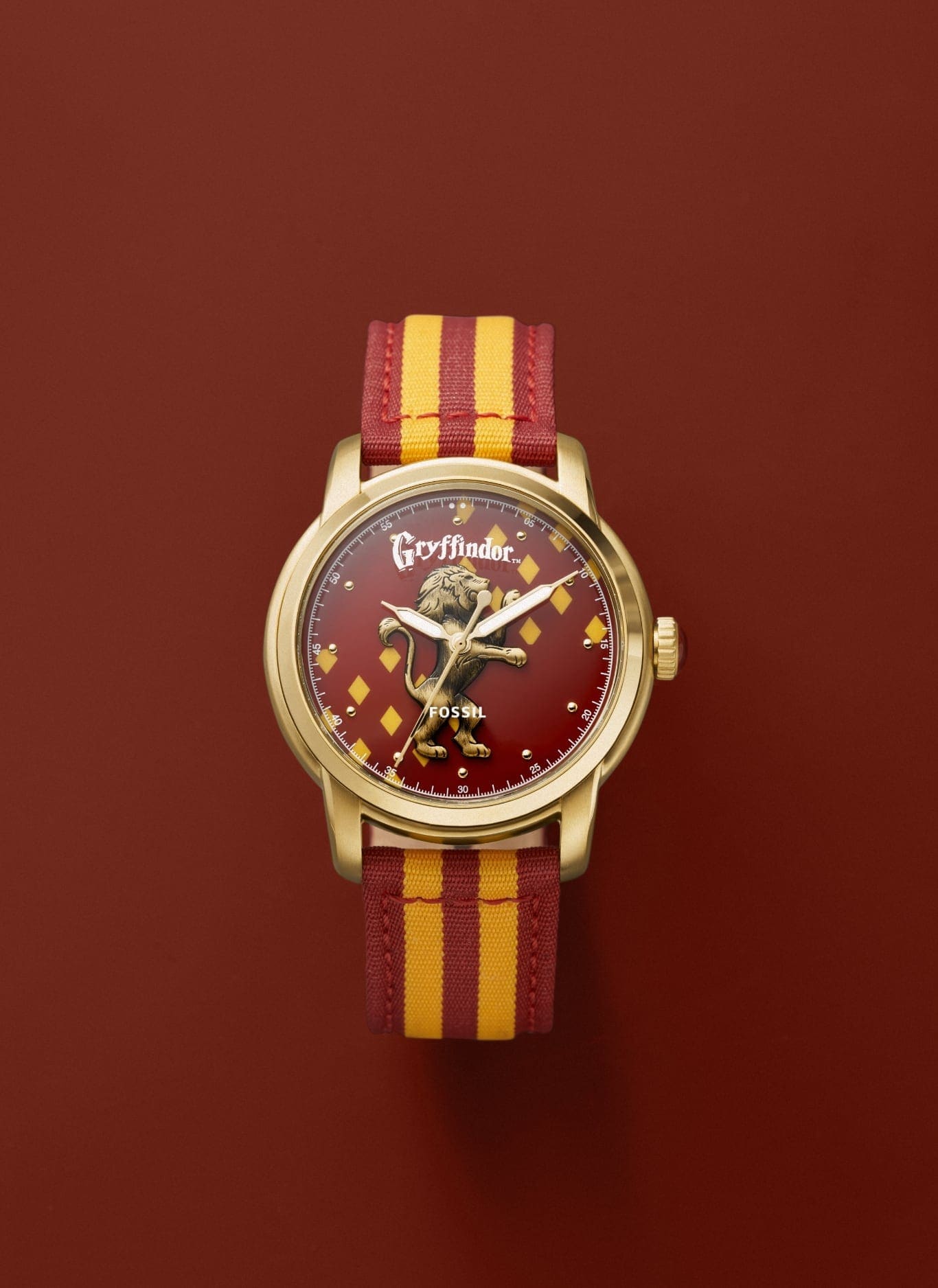 Gold-tone Gryffindor house watch with a red and gold strap.