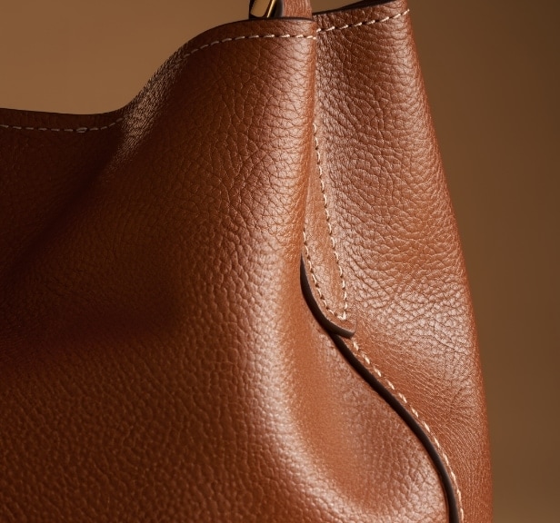 A closeup of the brown leather Jessie Bucket bag.