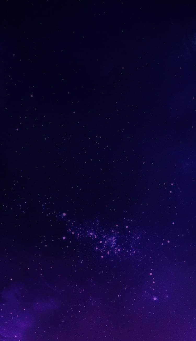 A blurred view of two watches on a dark, intergalactic background.