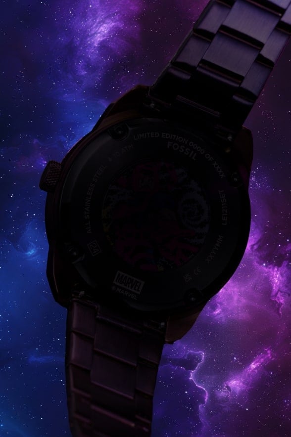 Blurred view of a round oversized watch silhouette on a glowing purple intergalactic background.