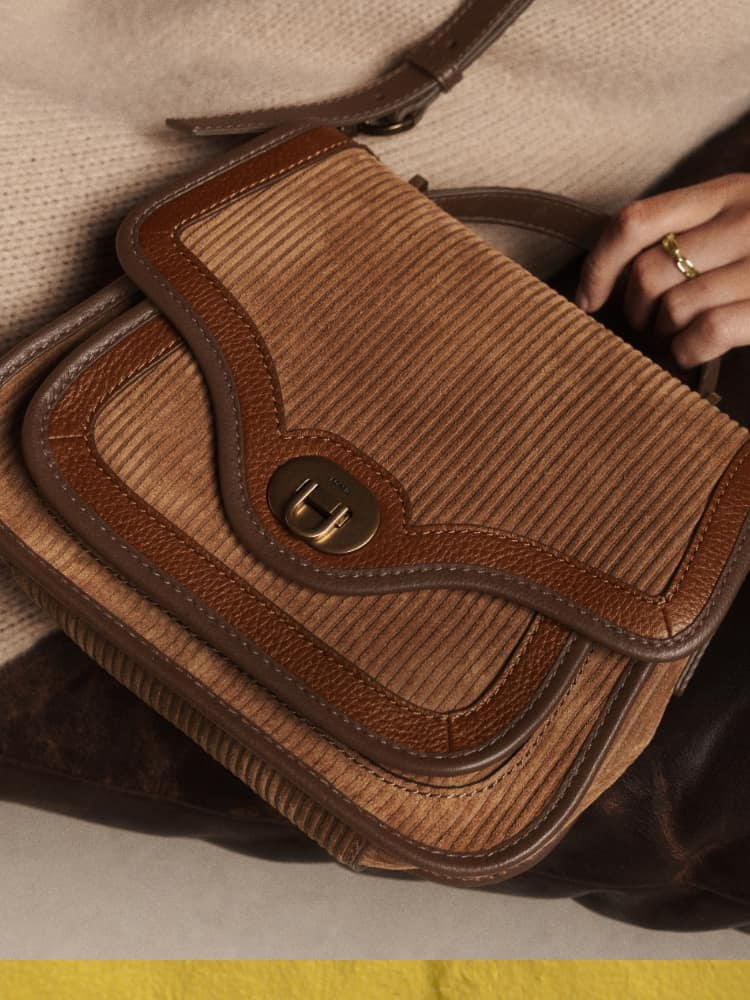 A brown suede Fossil Heritage handbag.