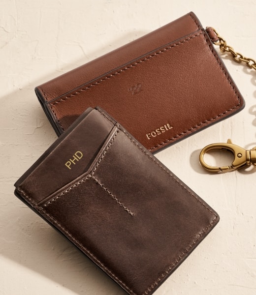 Two men’s brown leather wallets.