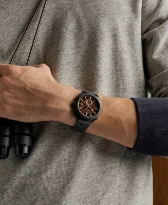 Lifestyle image of a man wearing a tan leather jacket, black sunglasses and the rugged Machine watch.