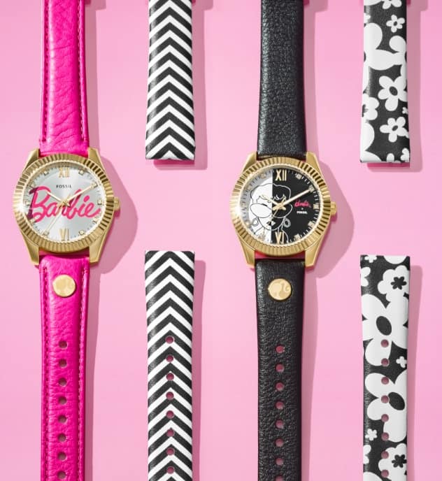 The two special-edition watch styles are shown with interchangeable straps that are included with each set. The watch on the left features the scripted Barbie signature on the dial, shown with a hot pink leather strap and additional black and white chevron strap. The watch on the right features a graphic black and white dial with a vintage-inspired illustration of Barbie. It’s shown with a black leather strap and additional black and white floral print strap.