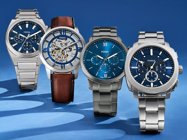 Four men's watches lined up on a black background.