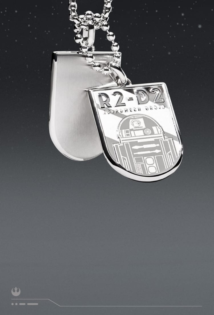 A silver-tone necklace with an engraving of R2-D2 on an ID plaque