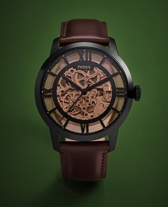 The Fossil Townsman automatic watch featuring a rose-gold tone skeletonised dial and deep brown finish.