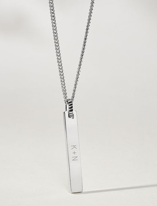 Image of a silver-toned, engraved vertical bar Fossil necklace.