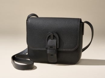 A black shoulder bag with a bold buckle.