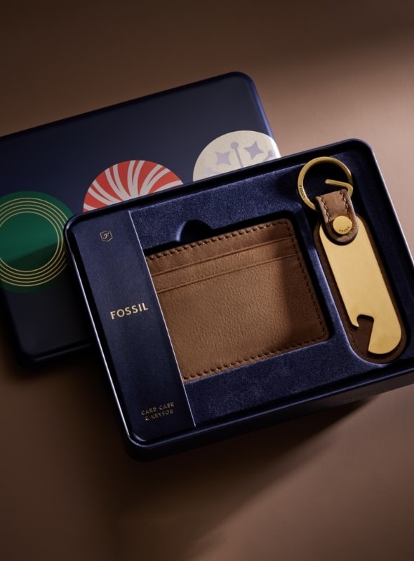 A gift set featuring a brown leather wallet and bottle opener keyfob.