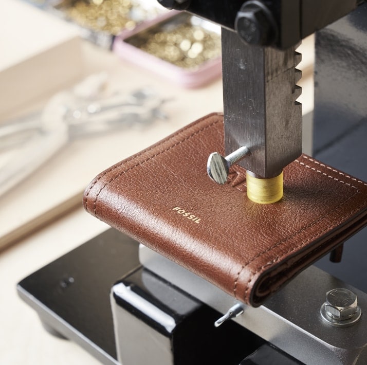 Leather wallet being personalized.