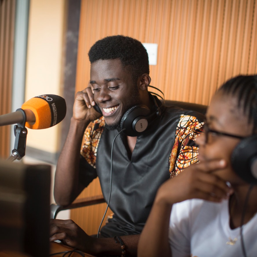 Two young adults in a recording booth