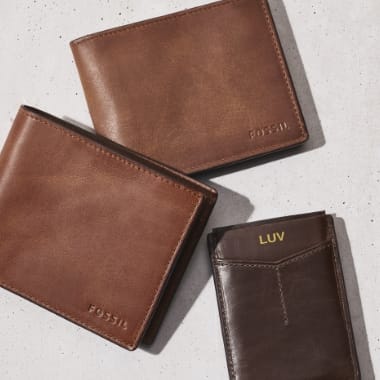 Three brown leather men's wallets.