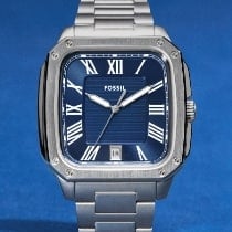 A man wearing a silver-tone watch.
