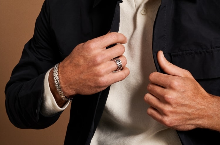 A man wearing silver-tone Arden ring and bracelet.