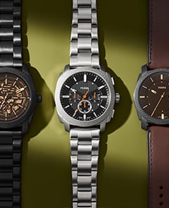 Three Machine watches laid flat on a green background.