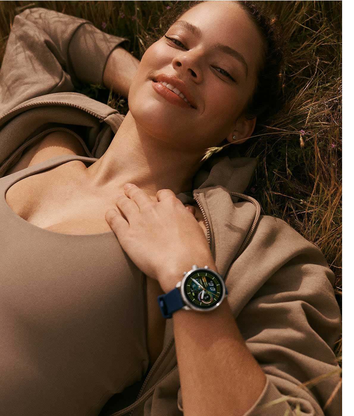 A woman lying down wearing Gen 6 Hybrid Wellness Edition.