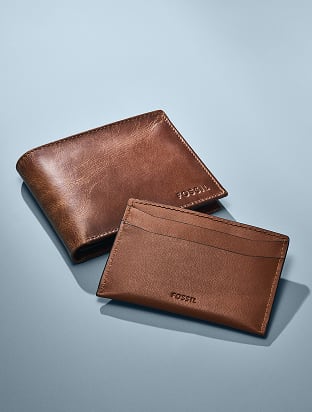 A Fossil brown leather bifold wallet.