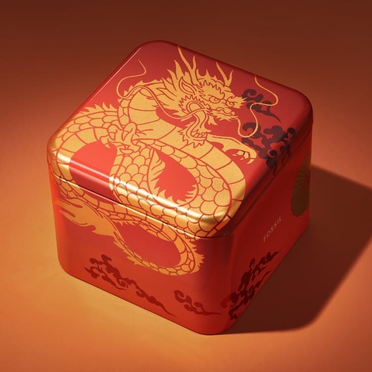 Una scatola in latta rossa con grafiche del drago per il capodanno lunare.