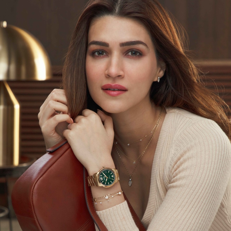 Image of female model with a Fossil watch and accessories.