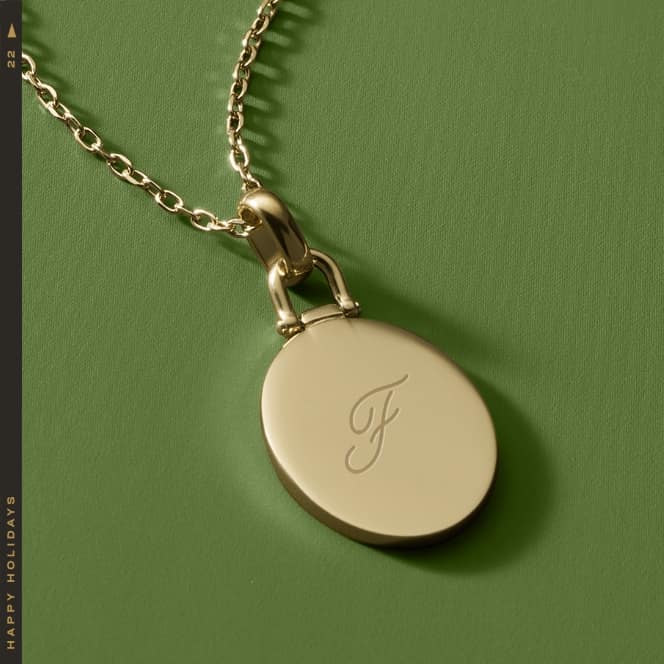 A gold-tone necklace engraved with XO.