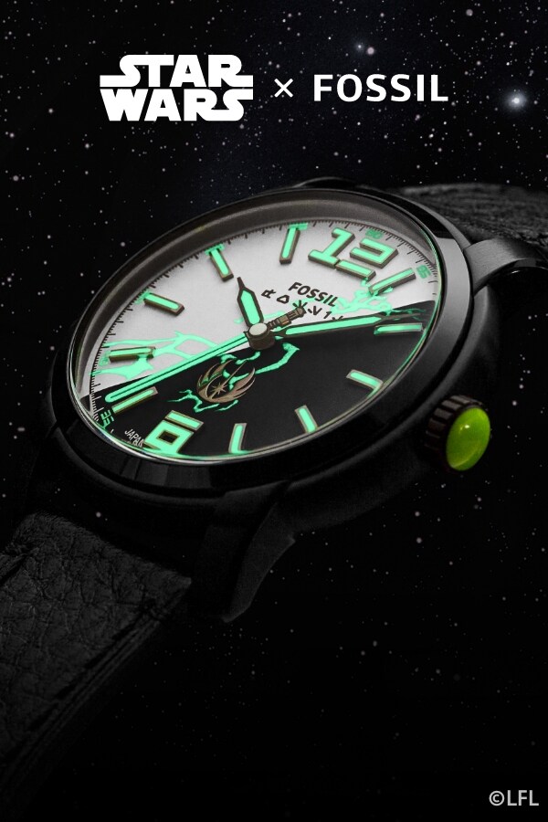 A close-up of a black watch with a black and white dial, glowing numbers and hands and force lightning on the dial. 