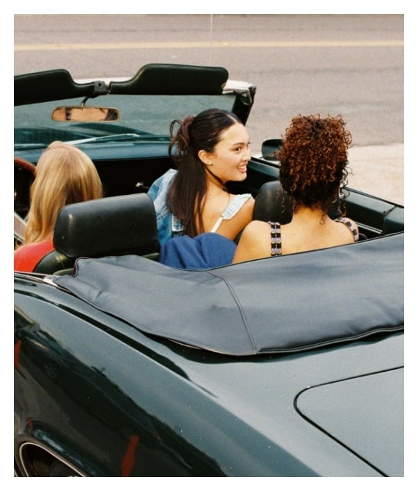 A group of friends in a vintage car.