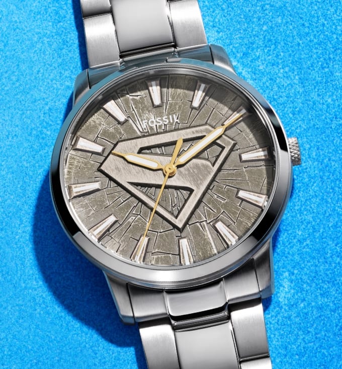 Superman watch featuring a brushed metal finish, S-shield emblem and fractured-effect dial.