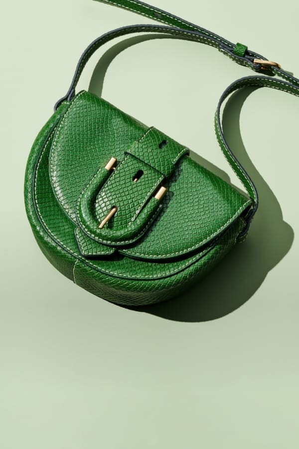 A green python-embossed leather Harwell mini bag. 