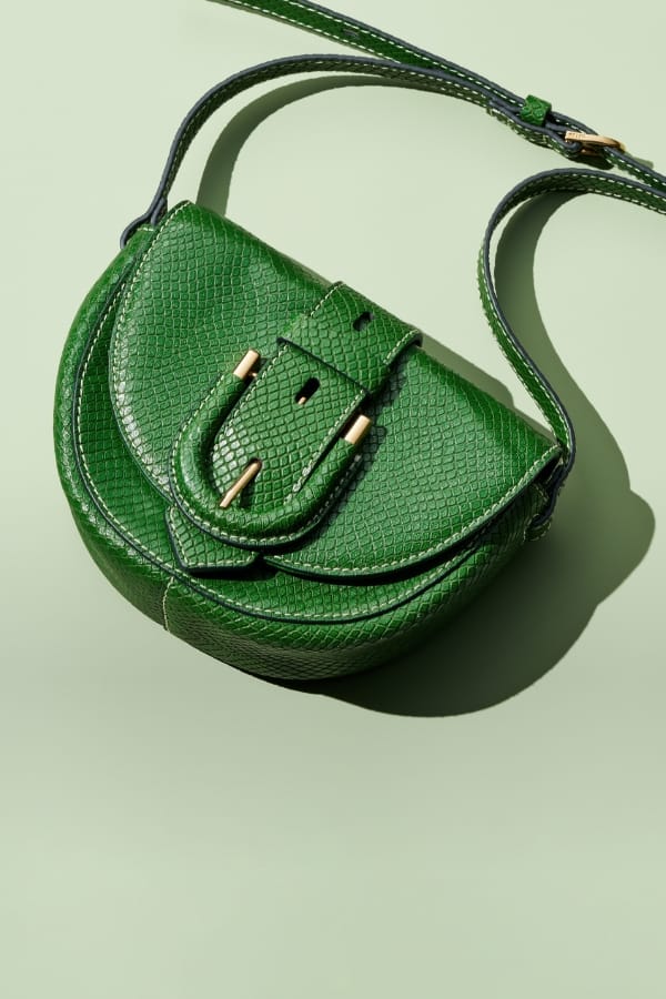 A green python-embossed leather Harwell micro bag.