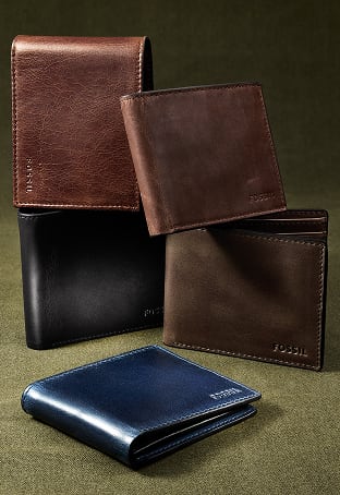 A lineup of leather bifold wallets in black, brown and navy blue.