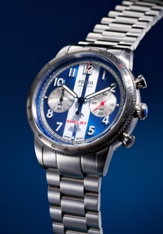 Two views of the Shelby Grand Tourer chronograph watch, highlighting the iconic blue and white striped dial, and stainless steel case and bracelet.