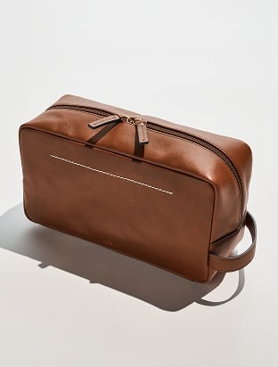 A brown leather dopp kit.